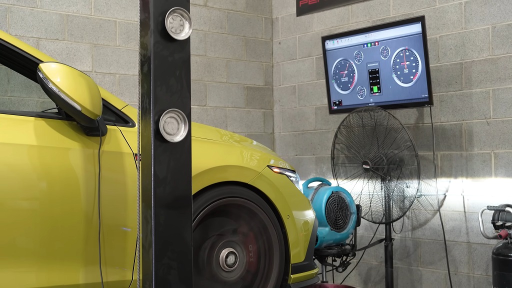 Car undergoing ECU car tuning on a dynamometer, with a screen showing performance diagnostics