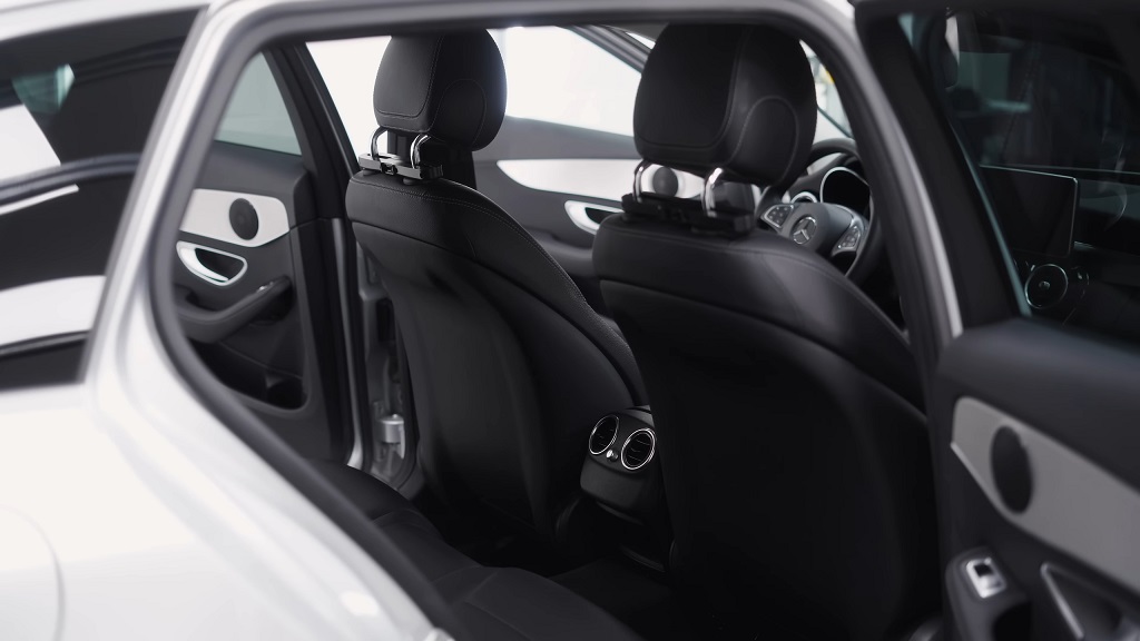 Rear seat interior of a luxury car, featuring comfort-focused design and clean aesthetics