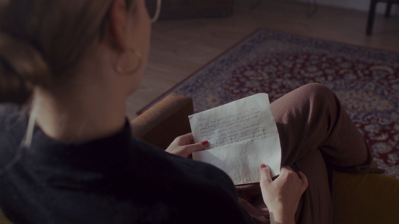 Mother reading a handwritten note from her children, capturing a heartfelt Mother's Day moment of appreciation
