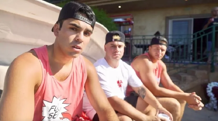 Members of the Nelk Boys crew sitting outdoors in a relaxed setting