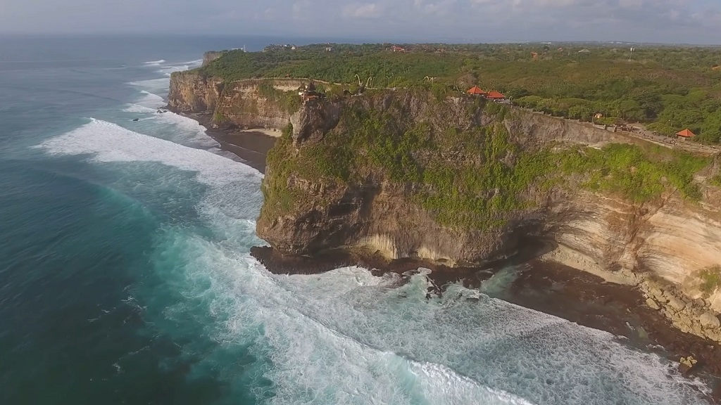 Aerial view of dramatic sea cliffs with pathways and coastal vegetation