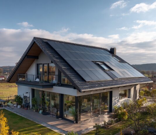 An image of a house with a rooftop covered with solar panels.