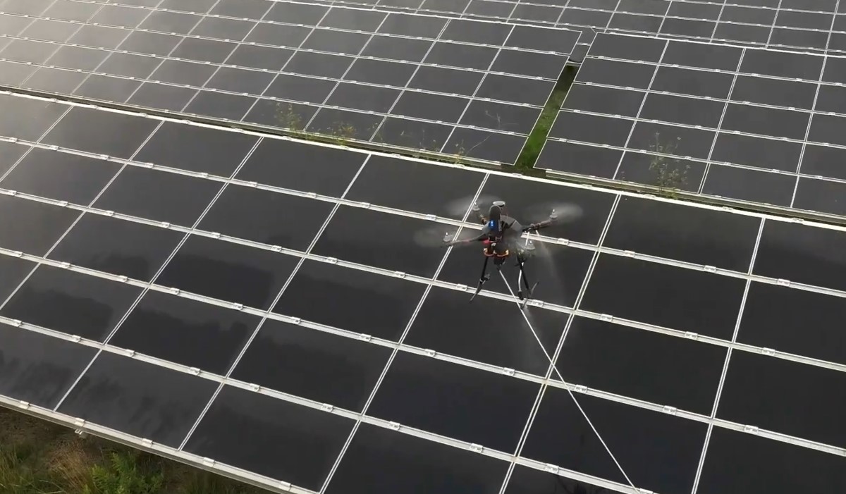 An image showing the solar panel cleaning process with Chronos drone.