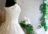 A lace gown on display highlights current bridal fashion trends for 2025