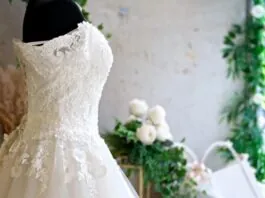 A lace gown on display highlights current bridal fashion trends for 2025