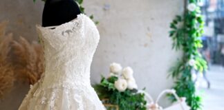 A lace gown on display highlights current bridal fashion trends for 2025