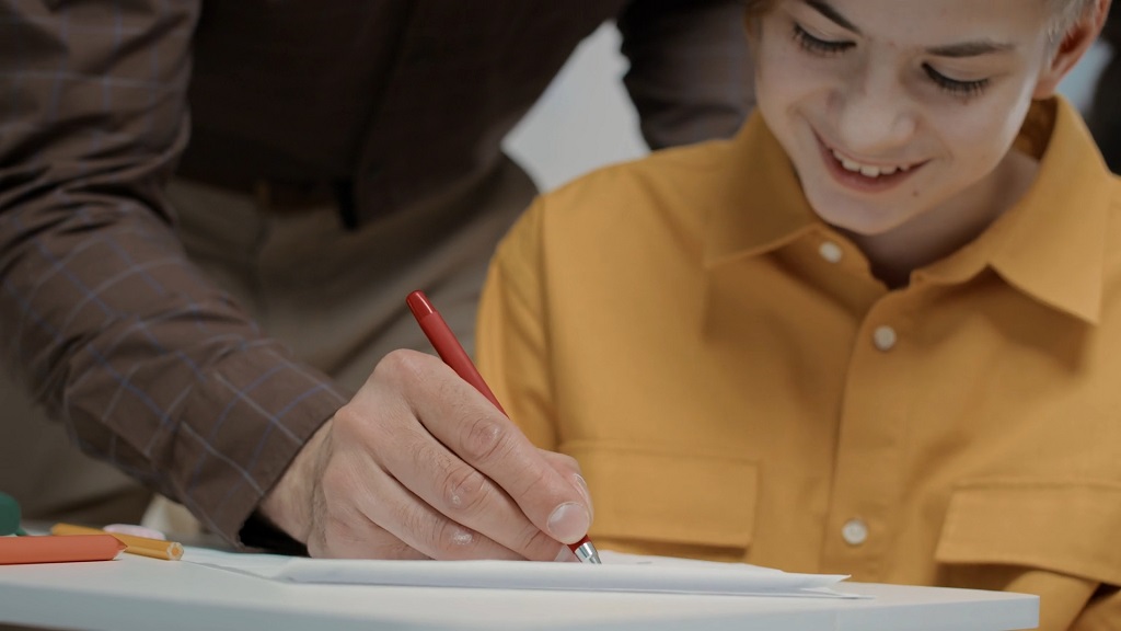 Teacher providing written feedback during a writing activity
