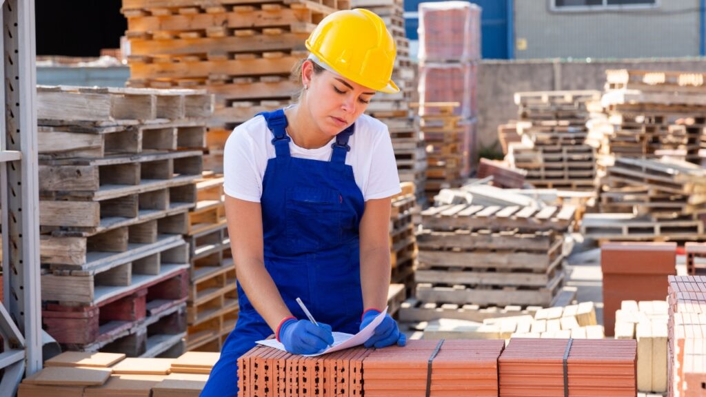 Worker checks construction materials on site during procurement and storage planning