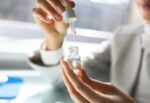 Medicare Opens The Door To CBD, But Product Standards Remain The Big Problem A person measures CBD oil with a dropper in a small glass bottle